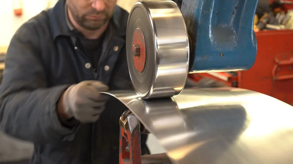 Shaping an aluminium panel on the English wheel in the Julian Parker Ltd workshop